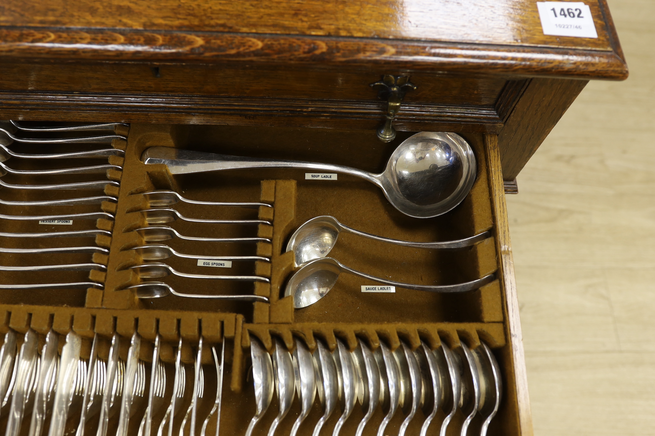 An oak standing canteen with two drawers of Mappin and Webb silver plated cutlery, settings for twelve people, 78cm high x 70cm wide x 54cm deep